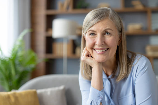 istock Confident senior woman smiling at home, feeling content 2151014749