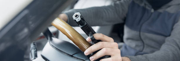 istock man hand gun in car 2151015550