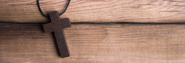 istock wooden cross on wooden background 2151016121