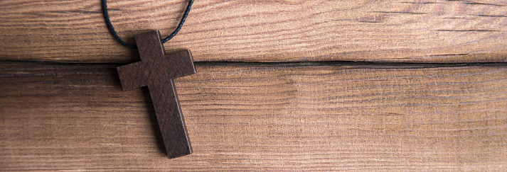 wooden cross on the wooden background