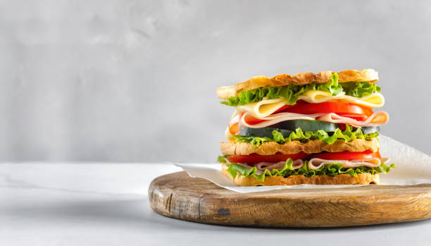 istock Big sandwich with vegetables and ham copy space 2151016374