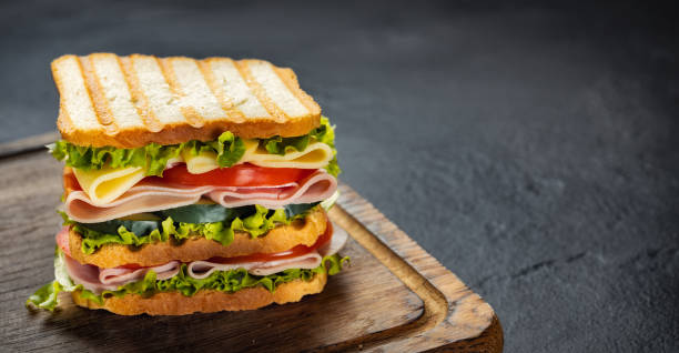 istock Big sandwich with vegetables ham and cheese copy space 2151016681