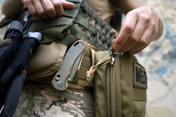 istock A soldier, a tactical medic opens a first aid kit, close-up view. 2151020369