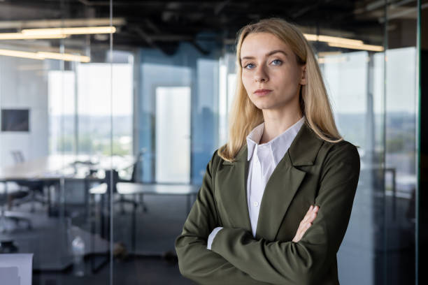 istock Confident businesswoman standing in modern office space 2151020752