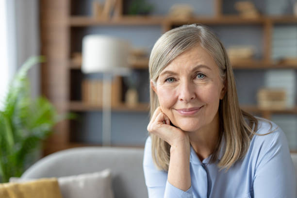istock Senior woman smiling warmly in a cozy home setting 2151024714