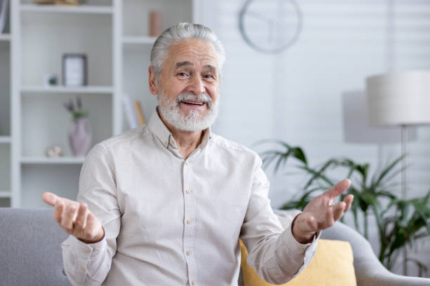 istock Senior man in video call with a casual expression at home 2151025609