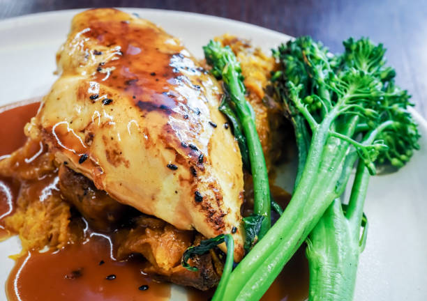 Lean Chicken Breast Meat with Gravy and garnished with green broccoli