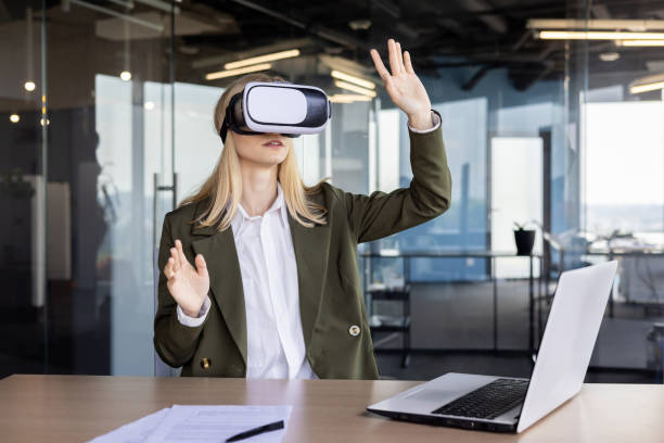 istock Businesswoman exploring virtual reality in modern office 2151029653