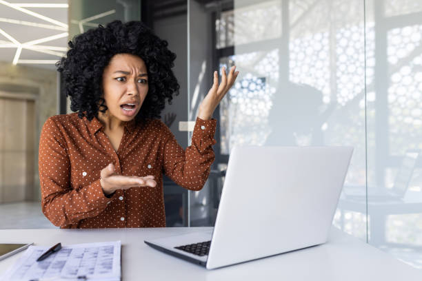 istock Angry businesswoman frustrated with computer in office 2151029752