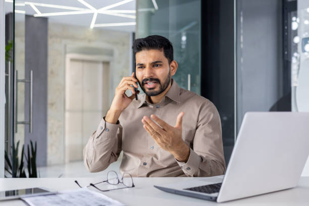istock Businessman looking frustrated while talking on the phone 2151029808