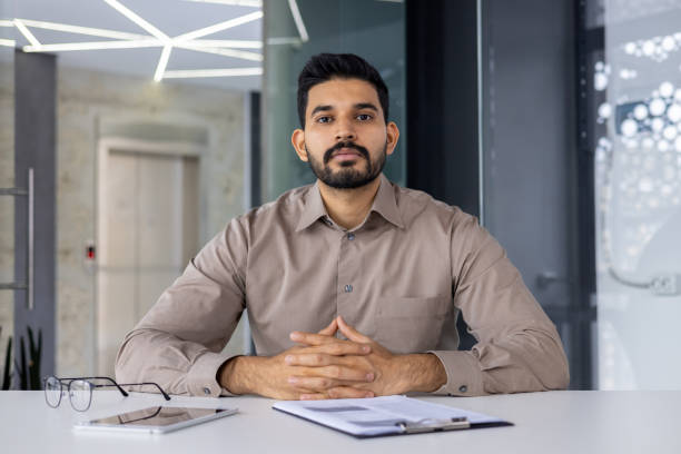 istock Hispanic businessman in a video call at modern office 2151029933