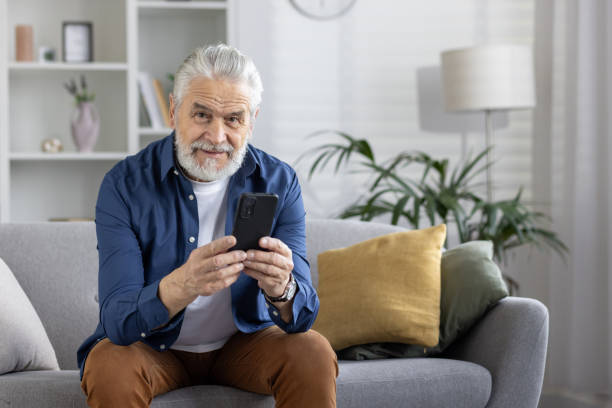 istock Senior man using phone with a big smile at home 2151030200