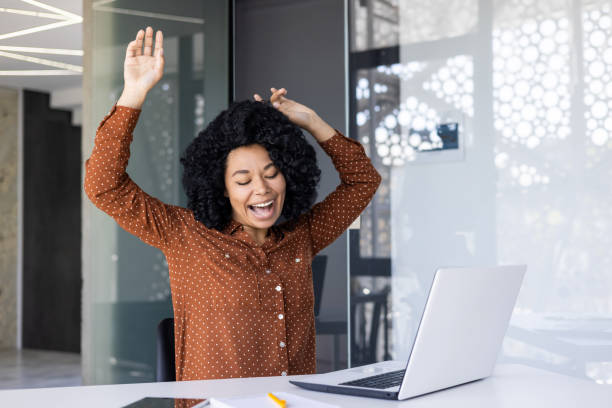 istock Joyful woman dancing and singing in modern office 2151030748