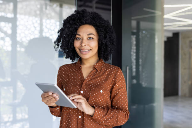 istock Professional woman with tablet posing confidently in office 2151031619