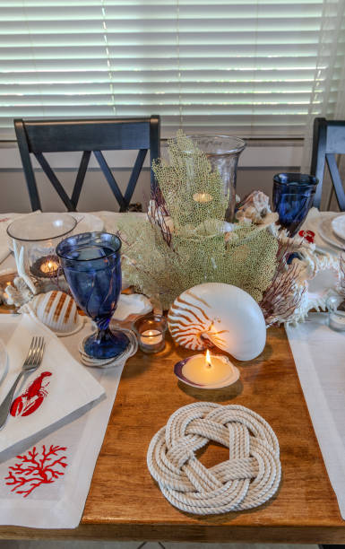 istock Seashell and candle decoration on a nautical table setting with natural colors 2151032561