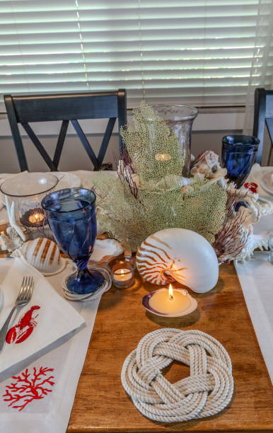 istock Seashell and candle decoration on a nautical table setting with natural colors 2151032562