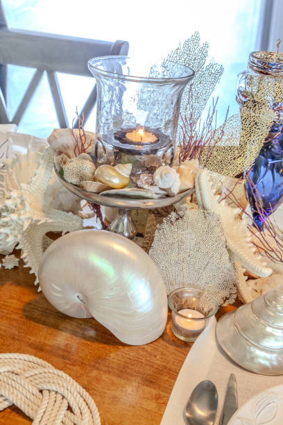 istock Seashell and candle decoration on a nautical table setting with natural colors 2151032565