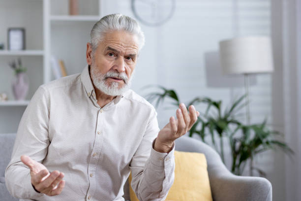 istock Senior man having a video call with a doctor from home 2151033080