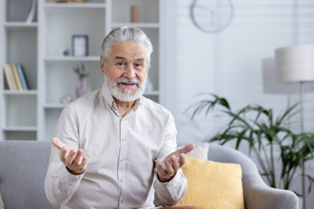 istock Senior man engaging in a video call from home 2151036403
