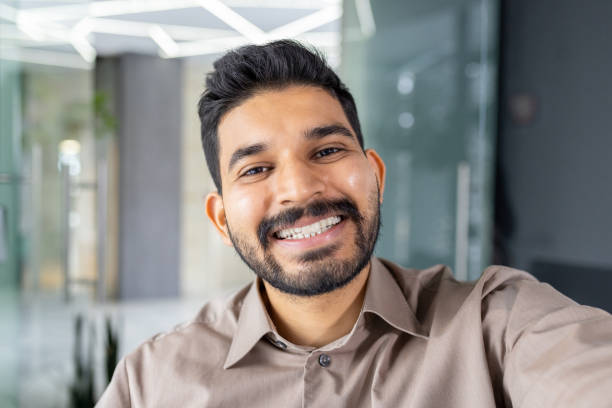 istock Smiling young man making a video call on his phone 2151036515