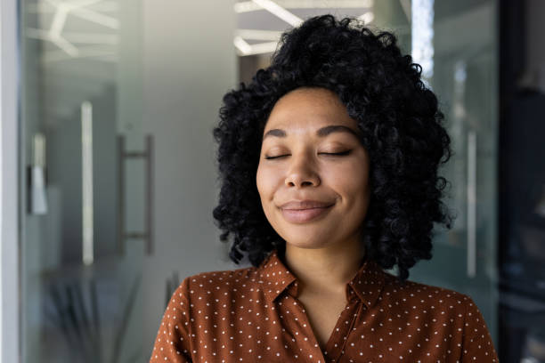 istock Content Black woman enjoying peaceful moment in office 2151037588