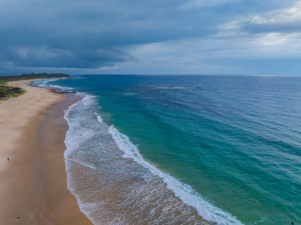 istock Sunrise Seascape with beautiful cloud covered sky and gentle surf 2151038257
