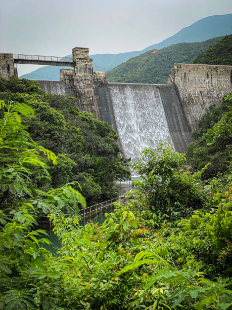 istock Waterfall Flowing from a Large Dam in Lush Greenery 2151038308