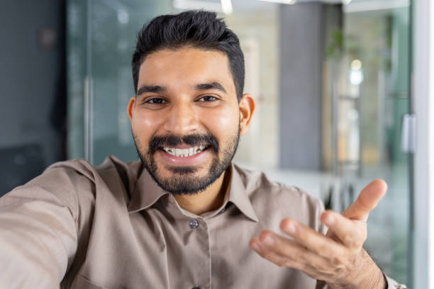 istock Businessman smiling and talking on phone in office 2151038825