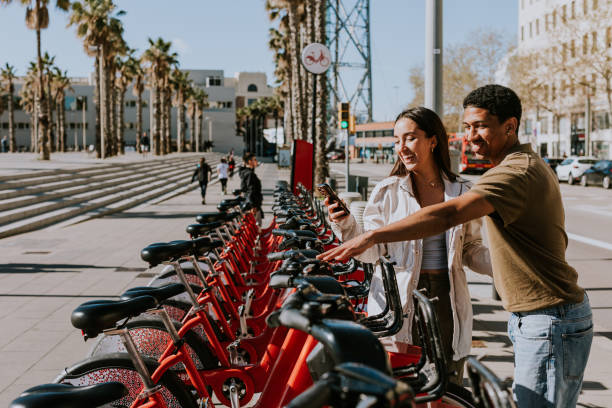 istock Intimate moment shared between a couple selecting public bicycles in sunny Barcelona 2151040442