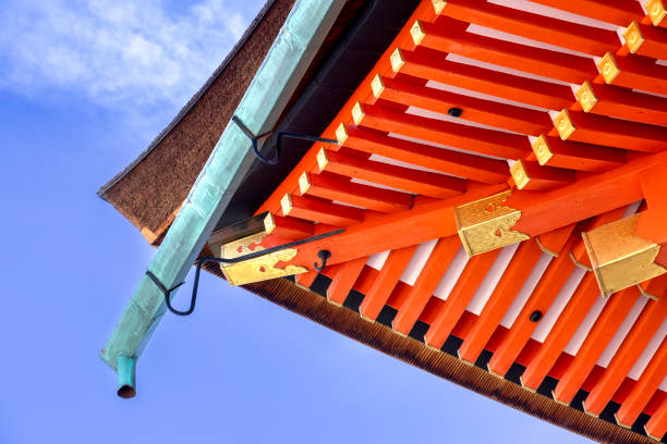 Kyoto, Japan - October 10th, 2023: Detailed Close-up view of the decorative red Kiyomizu-dera Pagoda under a blue autumn sky in Kyoto Japan.