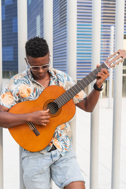 istock Stylish Guitarist Playing Music in Urban Setting 2151044411