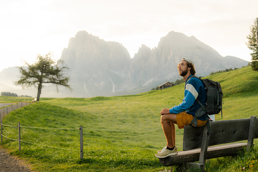 Man resting during the hike in Dolomites  in summer