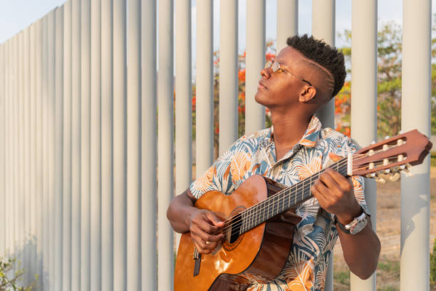 istock Serene Guitarist Enjoying Sunset Music Session 2151044596