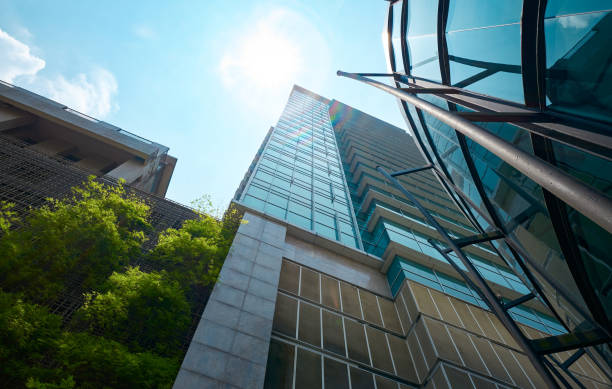 istock Modern glass buildings and green with bright sky 2151044878