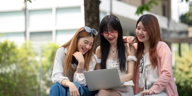 istock Asian young campus student enjoy learn study and reading books together. Friendship and Education concept. Campus school and university. Happiness and funny of learning in college 2151046139