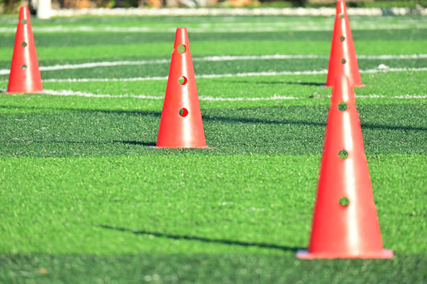 istock artificial green grass soccer field with orange training cones 2151046152