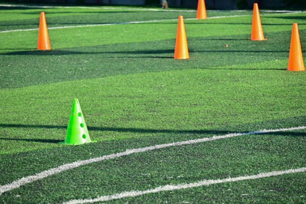 istock artificial green grass soccer field with training cones 2151046157