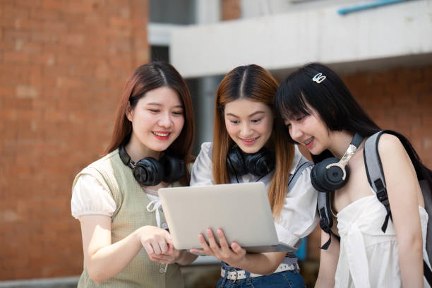 istock Asian young campus student enjoy learn study and reading books together. Friendship and Education concept. Campus school and university. Happiness and funny of learning in college 2151046164