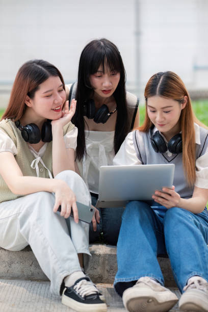istock Asian young campus student enjoy learn study and reading books together. Friendship and Education concept. Campus school and university. Happiness and funny of learning in college 2151046175