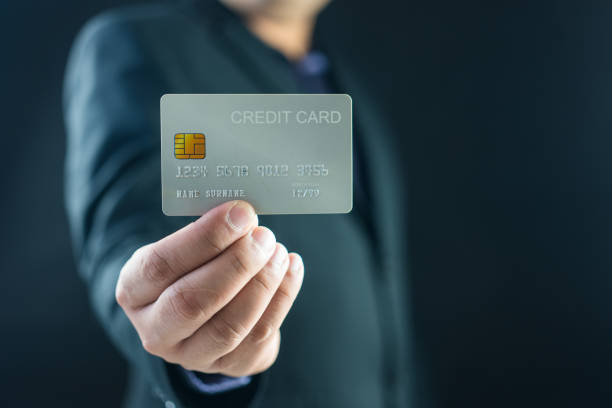 istock Businessman holding his credit card 2151046434