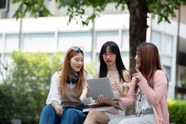 istock Asian young campus student enjoy learn study and reading books together. Friendship and Education concept. Campus school and university. Happiness and funny of learning in college 2151047446