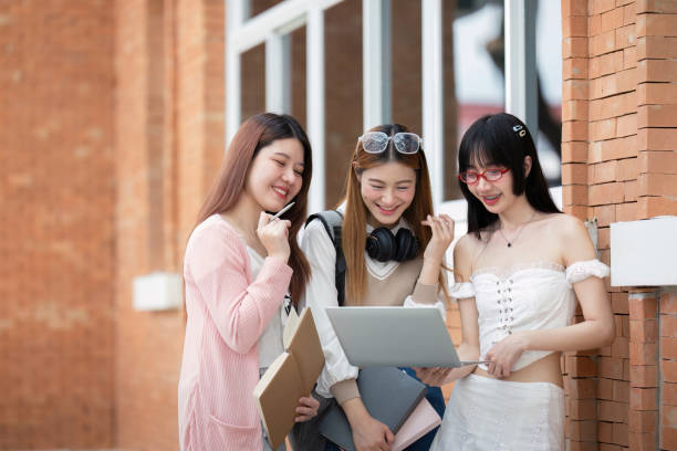 istock Asian young campus student enjoy learn study and reading books together. Friendship and Education concept. Campus school and university. Happiness and funny of learning in college 2151047467