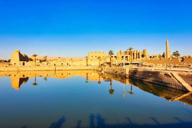 View of the Karnak Temple Sacred Lake-the largest of its kind,built by Pharoah Tuthmosis III around 1460 BC used for sacred rituals at the Karnak temple complex dedicated to Amun-Re in Luxor,Egypt