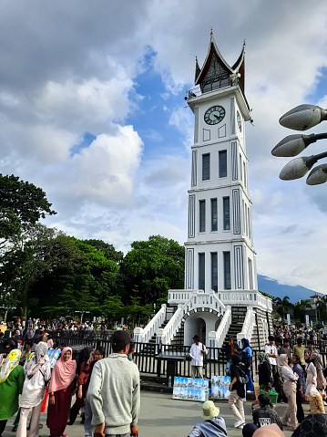 Bukittinggi, Indonesia - April 28, 2024: Bukittinggi Clock Tower, one of the historical heritages in Indonesia since the Dutch colonial era in 1928 and is now used as a tourist attraction in Bukittinggi City, West Sumatra, Indonesia. This photo is suitable for something with the theme of historical buildings and tourist destinations