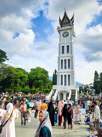 Bukittinggi, Indonesia - April 28, 2024: Bukittinggi Clock Tower, one of the historical heritages in Indonesia since the Dutch colonial era in 1928 and is now used as a tourist attraction in Bukittinggi City, West Sumatra, Indonesia. This photo is suitable for something with the theme of historical buildings and tourist destinations