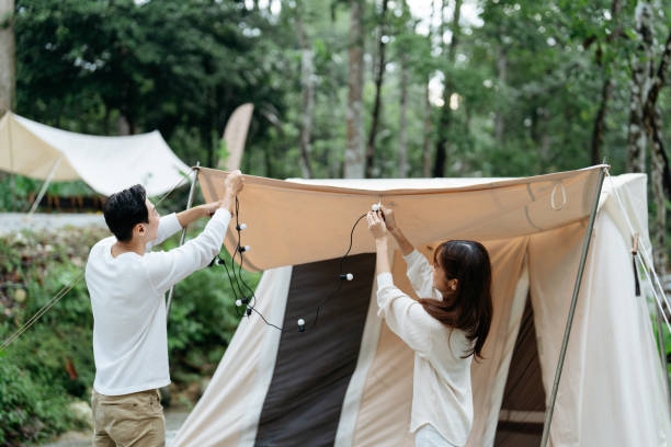 istock Campers setting up the tent in campsite 2151048853