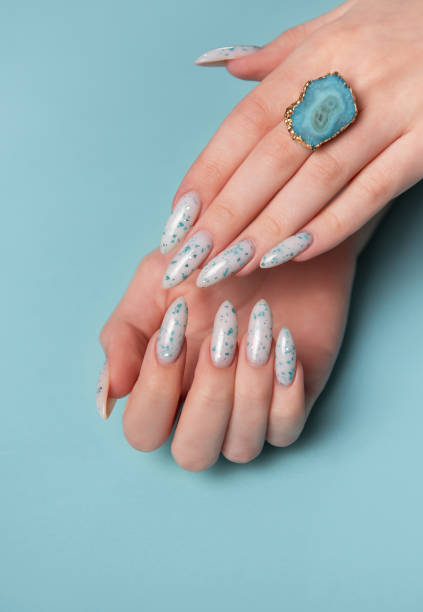 istock Female hands with blue nail design. Blue nail polish manicure. 2151051471