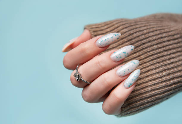 istock Female hands with blue nail design. Blue nail polish manicure. 2151051479