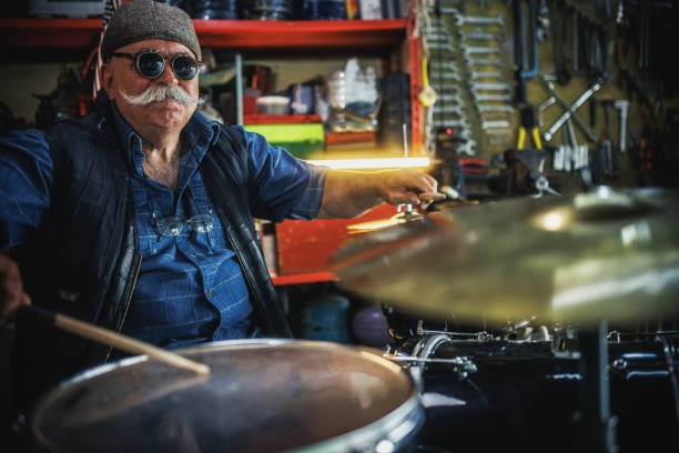 istock senior man plays drums in his garage 2151051491