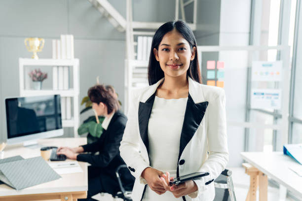 istock Portrait of a successful business woman using digital tablet at work inside office building. 2151052065